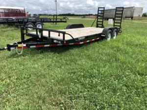 A trailer that is parked in the grass.